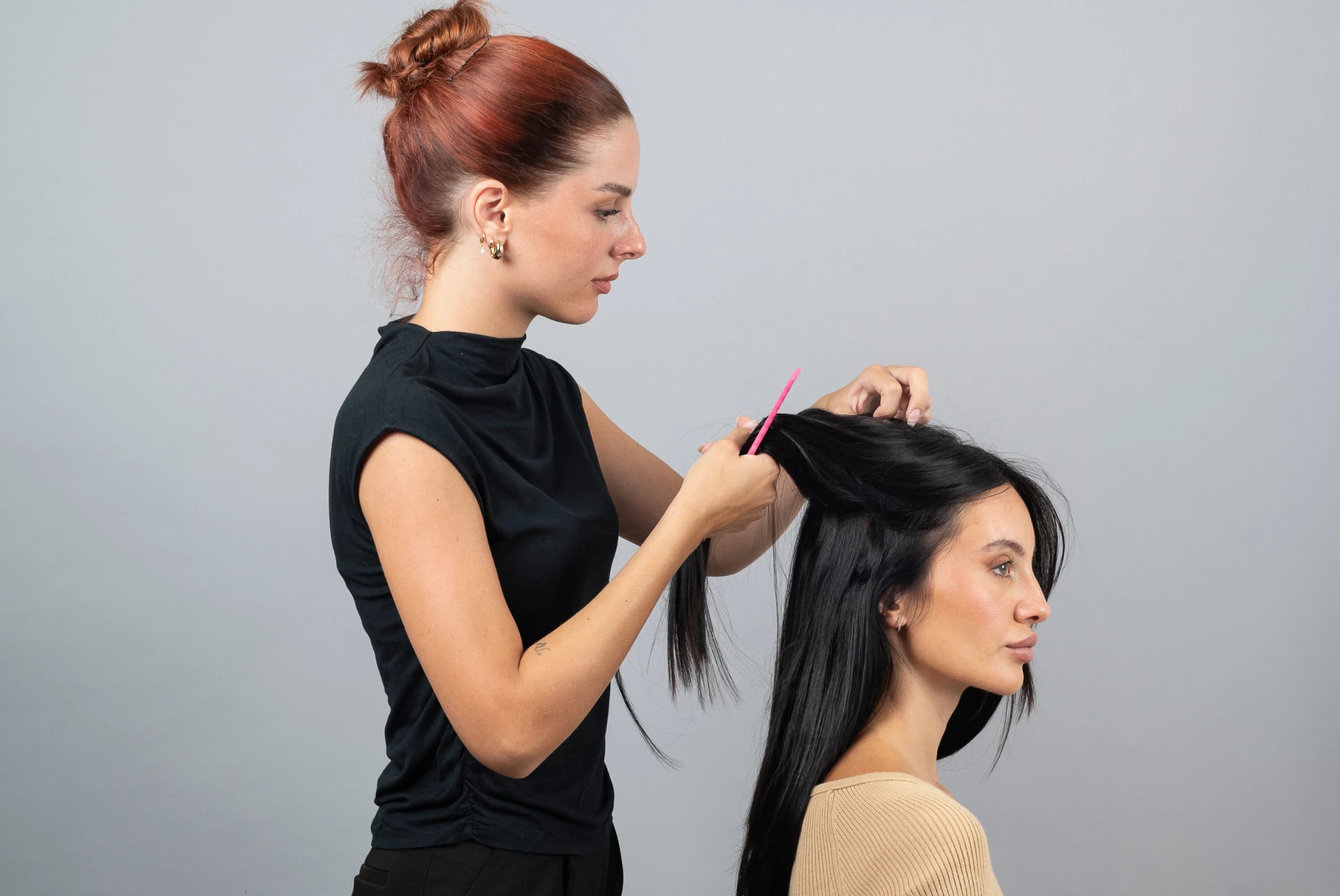 Professional stylist applying hair extensions