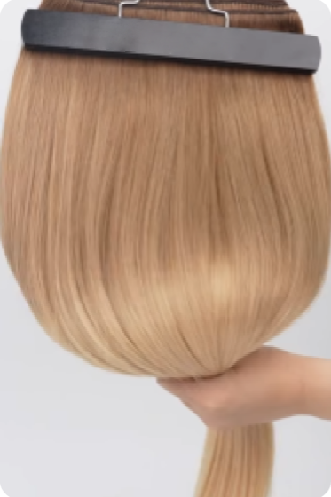 Blonde Remy hair extension held in hand